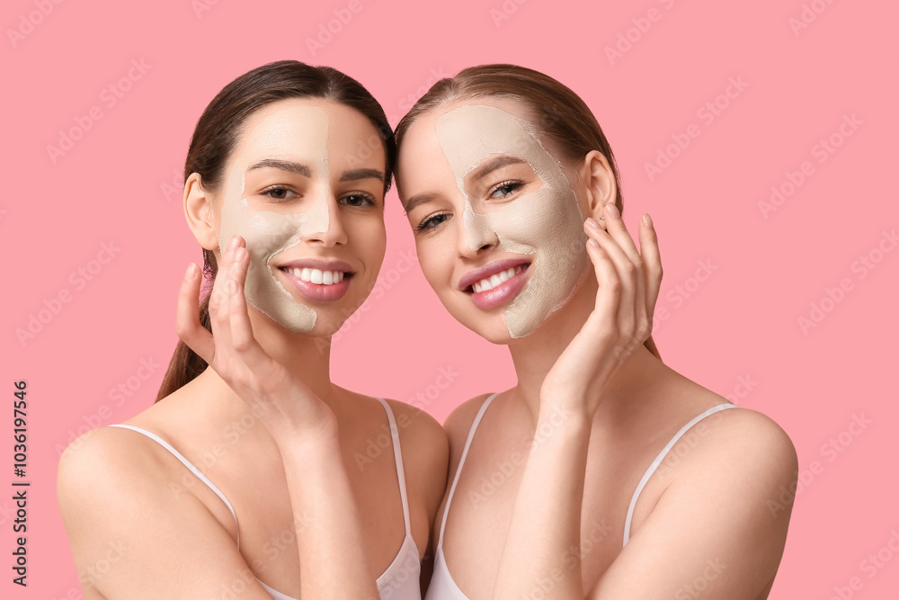 Beautiful young happy women with facial masks on pink background Beautiful young happy women with facial masks on pink background