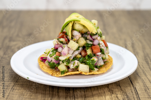 Wallpaper Mural Delicious looking shrimp tostada stacked high on a tortilla and topped with sliced avocado for an excellent Mexcian seafood meal Torontodigital.ca