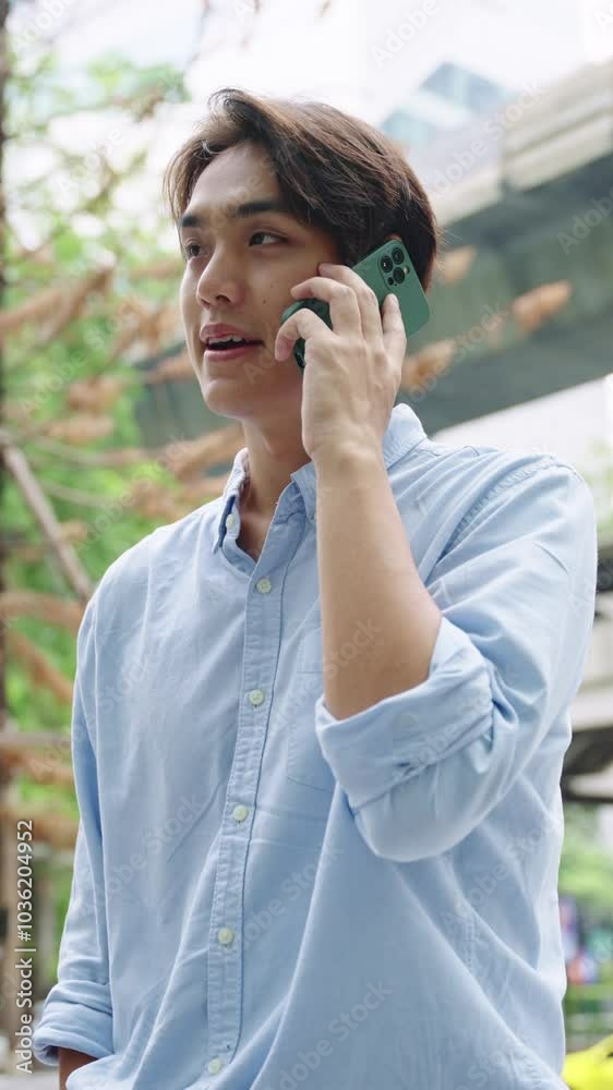 Young man receiving a phone call in slow motion - Bangkok Thailand Young man receiving a phone call in slow motion - Bangkok Thailand