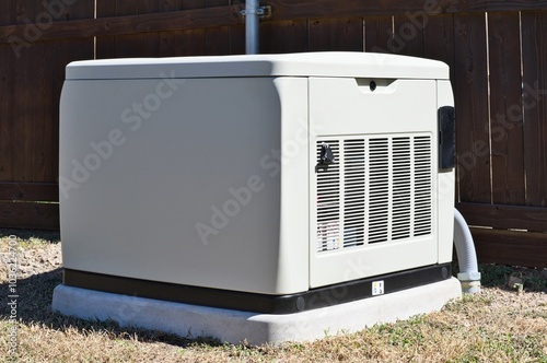 Standby home generator set in residential backyard emergency backup power supply.	