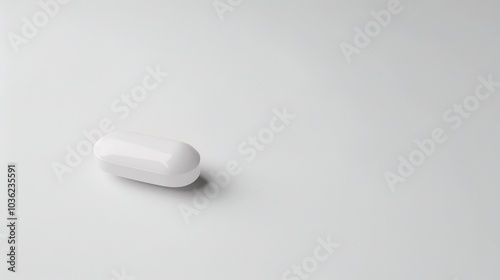 White medicine pill tablet on white background - a symbol of purity and healing. This pristine white pill on an equally white backdrop represents the potential for health and recovery