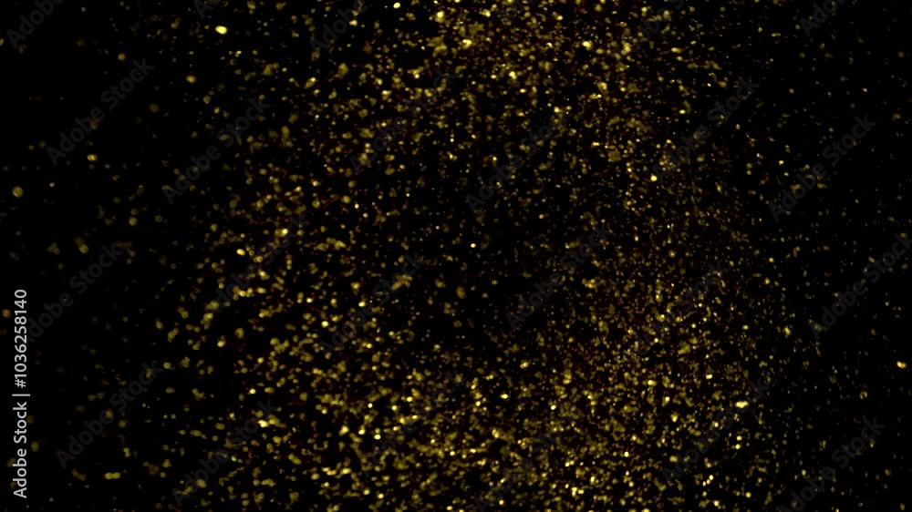 Super Slow Motion Shot of Golden Glittering Particles Isolated on Black with Rotation at 1000fps Super Slow Motion Shot of Golden Glittering Particles Isolated on Black with Rotation at 1000fps