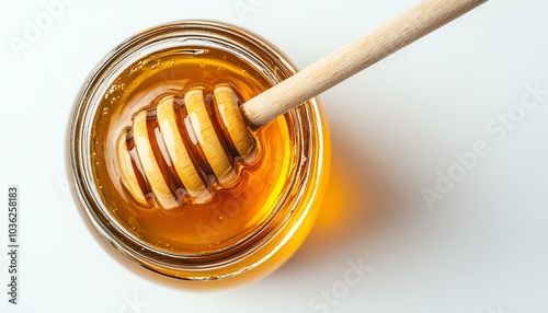 Honey jar with a wooden dipper captured from above on a white background, offering generous space for text and promotional messages