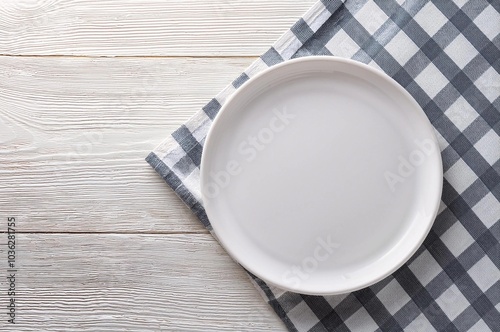 empty round white plate on tablecloth for food on white wooden background. Top view  photo