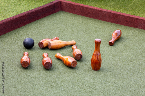 Close up texture background of lawn bowling pins and ball on a carpeted playing surface photo