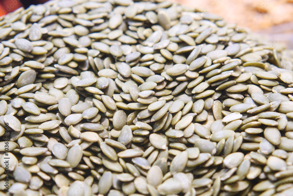 A CloseUp Image of Raw Green Pumpkin Seeds Beautifully Arranged on Display for Viewing A CloseUp Image of Raw Green Pumpkin Seeds Beautifully Arranged on Display for Viewing