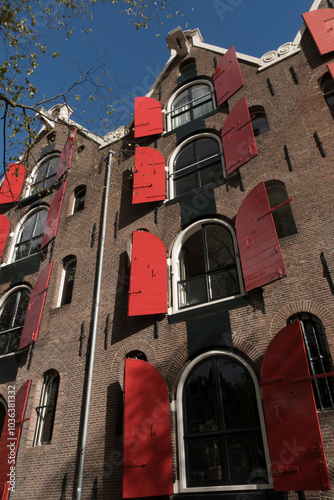 Canvas Print Opened windows of canal houses with red shutters in Jordaan - 3