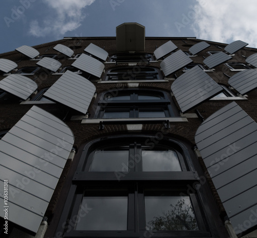 Wide angle of tall building  with gray opened shutters on Brouwersgracht - 2 photo