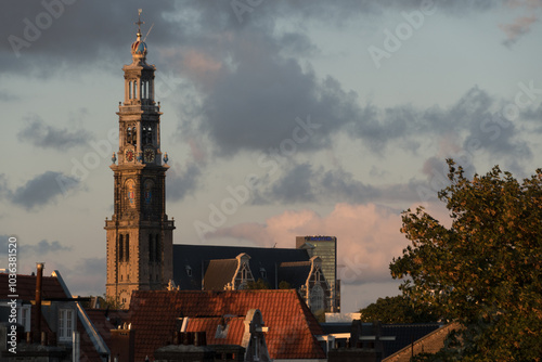 Glowing scarlet corlos highlight spear of Westerkerk photo