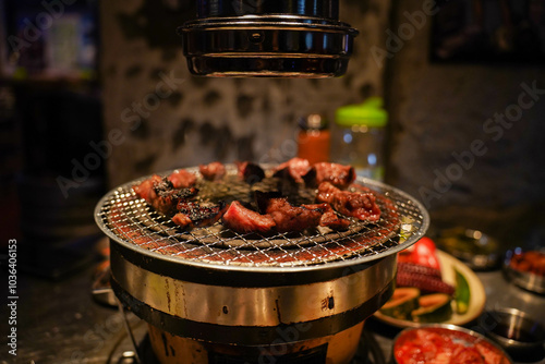 Obraz na płótnie Grilled meat on a charcoal grill pan at Korean BBQ restaurant. w salonie
