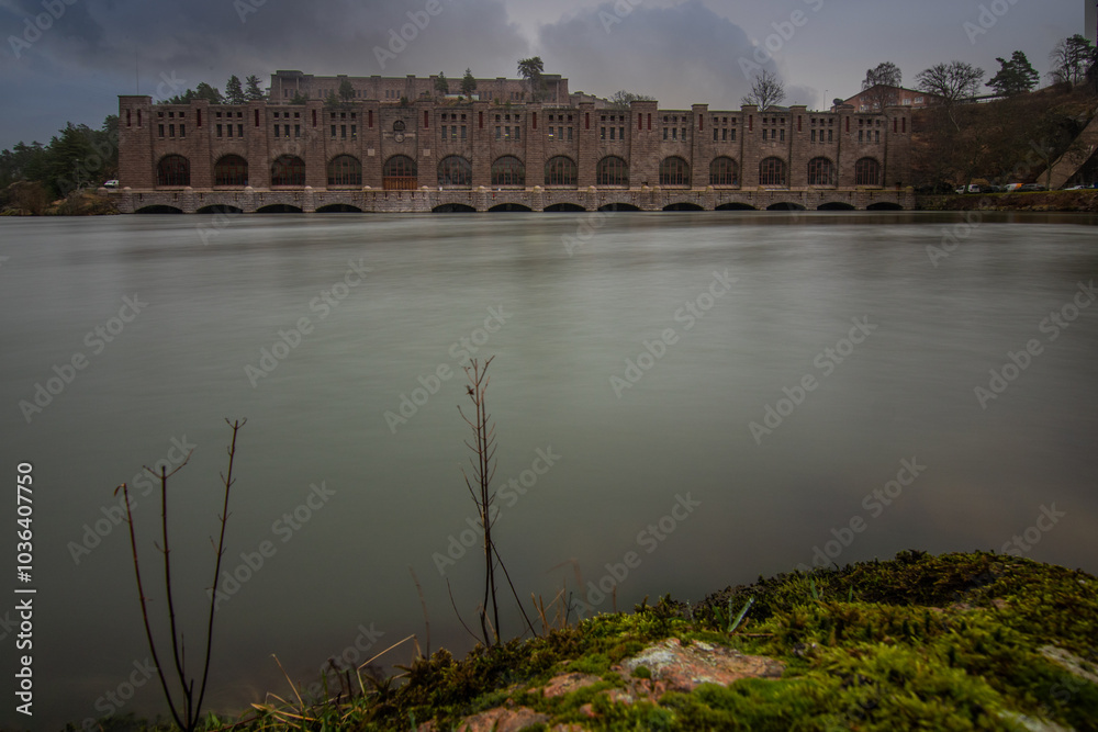 Historical sight, the red brick hydroelectric power station. Rainy weather at sunset by the river in Trollhättan, Sweden, Scandinavia Historical sight, the red brick hydroelectric power station. Rainy weather at sunset by the river in Trollhättan, Sweden, Scandinavia