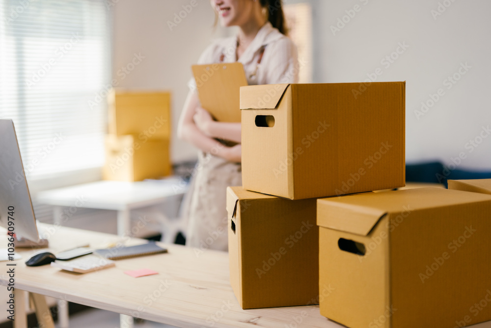 Young entrepreneur checking delivery orders on a tablet in her home office, managing her online business efficiently Young entrepreneur checking delivery orders on a tablet in her home office, managing her online business efficiently