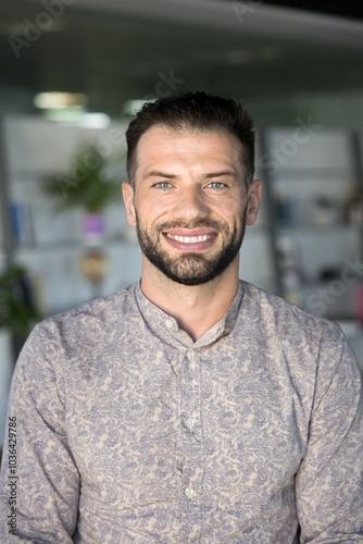 Happy attractive young business owner man, project manager, developer, company leader head shot vertical portrait. Handsome guy in casual shirt looking at camera with toothy smile