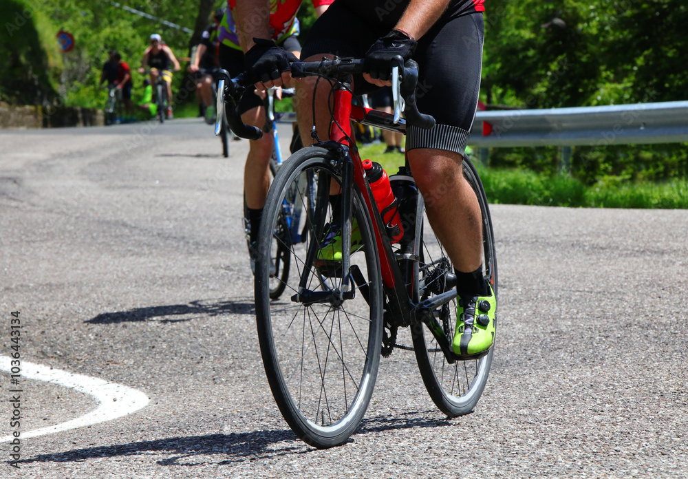 Naklejka premium cyclist riding a racing bike viewed from below during a cycling competition on the road