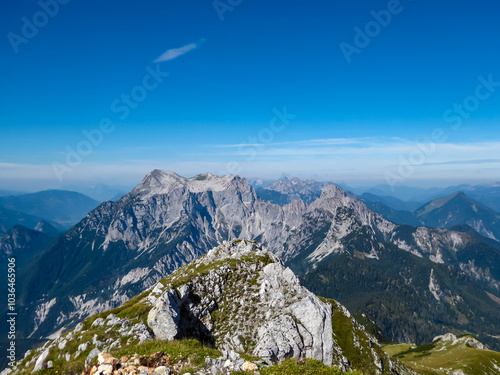 Panoramic view of majestic mountain range of Gesäuse, Ennstal Alps, Styria, Austria. Towering, jagged peaks rise up in Austrian Alps. Vistas from on top of peak Tamischbachturm. Wanderlust in summer photo