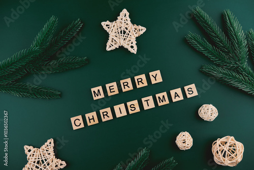 Merry Christmas background, top view. Wooden blocks on a darl emerald background.  photo