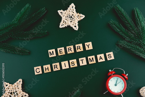 Merry Christmas background, top view. Wooden blocks on a darl emerald background.  photo