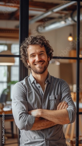 Portrait of a smiling entrepreneur in a startup office, embodying innovation and determination.