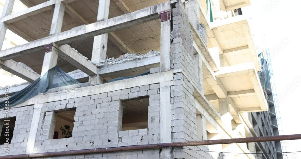 Building under construction stands tall with skeletal framework Building under construction stands tall with skeletal framework