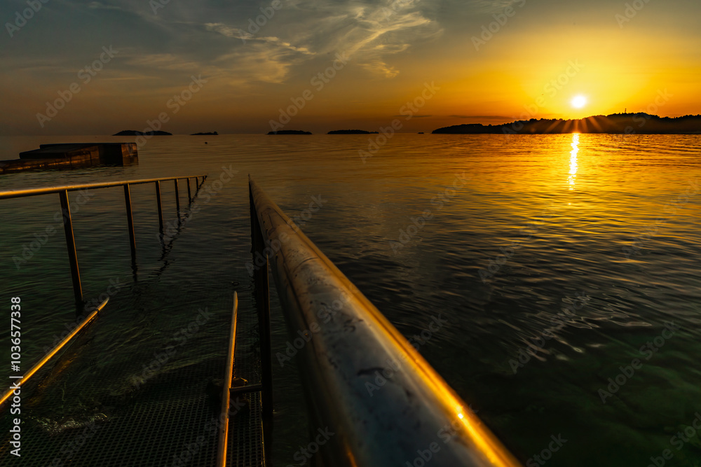 Guardrails, for going into the water, for wheelchairs, panorama at sunset Guardrails, for going into the water, for wheelchairs, panorama at sunset