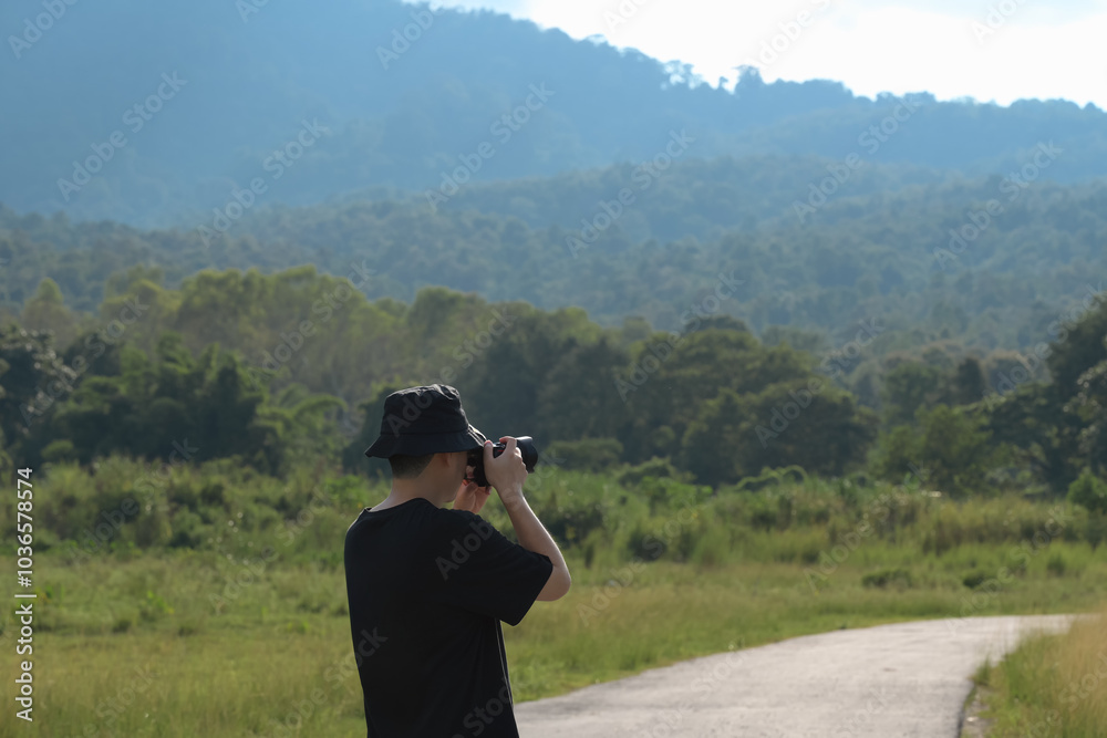 custom made wallpaper toronto digitalYoung man photographing the beautiful landscape with his camera. Travel and outdoor activities concept