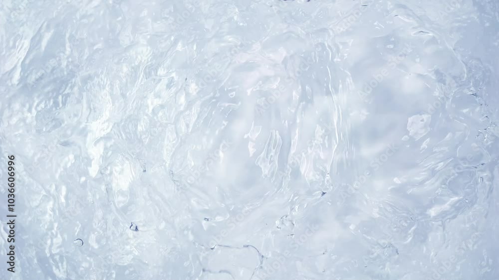 Abstract shot of rippling water in slow motion, with studio lighting enhancing the shimmering texture.
