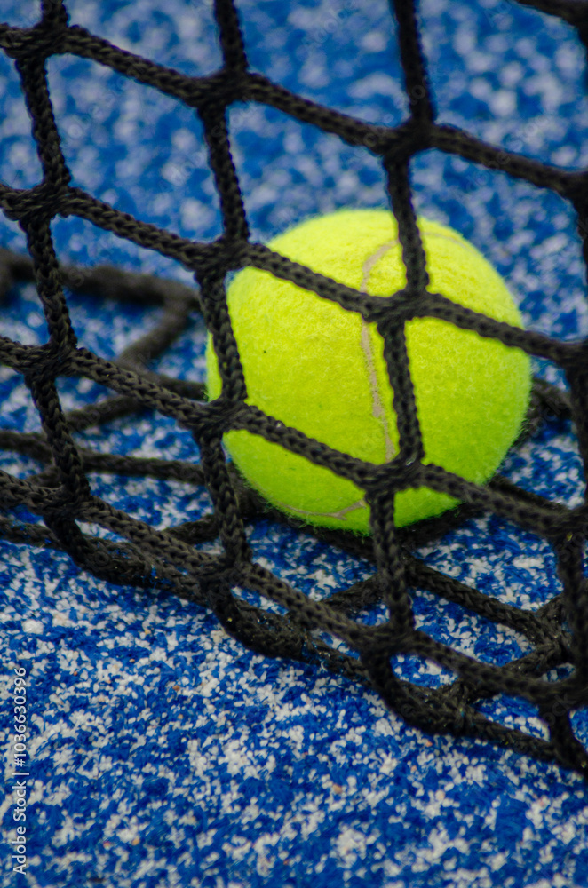 ball near the net in a blue padel tennis court, racket sports background concept ball near the net in a blue padel tennis court, racket sports background concept