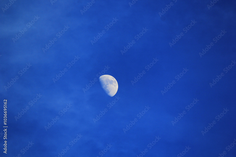 moon in the sky over the clouds in sunny day moon in the sky over the clouds in sunny day