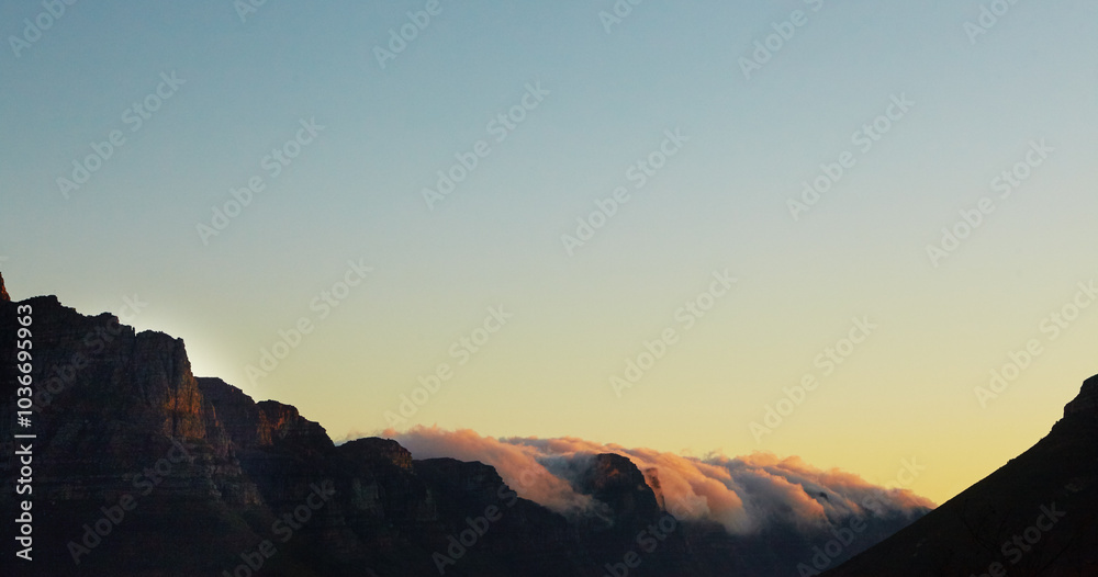 Clouds, environment and blue sky with sunset by mountain for summer, Earth and travel destination. Sustainability, background with scenery in nature for peaceful, natural and view of outdoor location Clouds, environment and blue sky with sunset by mountain for summer, Earth and travel destination. Sustainability, background with scenery in nature for peaceful, natural and view of outdoor location