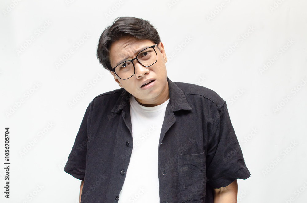 Thoughtful asian man thinking and wondering with hand touching skin as thinking gesture isolated over white background. asian man with glasses and black and white casual shirt feeling uncertain. Thoughtful asian man thinking and wondering with hand touching skin as thinking gesture isolated over white background. asian man with glasses and black and white casual shirt feeling uncertain.