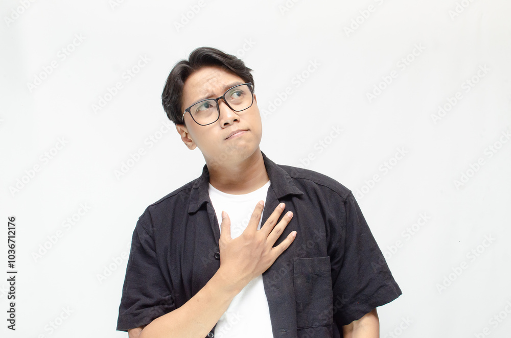 Thoughtful asian man thinking and wondering with hand touching skin as thinking gesture. Thoughtful confused asian man thinking and wondering to choose something. man feeling uncertain and unsure. Thoughtful asian man thinking and wondering with hand touching skin as thinking gesture. Thoughtful confused asian man thinking and wondering to choose something. man feeling uncertain and unsure.