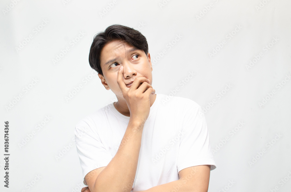 Thoughtful asian man thinking and wondering with hand touching skin as thinking gesture. Thoughtful confused asian man thinking and wondering to choose something. man feeling uncertain and unsure. Thoughtful asian man thinking and wondering with hand touching skin as thinking gesture. Thoughtful confused asian man thinking and wondering to choose something. man feeling uncertain and unsure.
