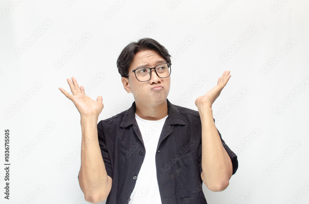 Thoughtful asian man thinking and wondering with hand touching skin as thinking gesture isolated over white background. asian man with glasses and black and white casual shirt feeling uncertain. Thoughtful asian man thinking and wondering with hand touching skin as thinking gesture isolated over white background. asian man with glasses and black and white casual shirt feeling uncertain.