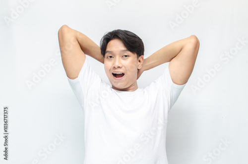 estactic attractive young asian man shocked happily opening mouth making wow expression as a surprise gesture