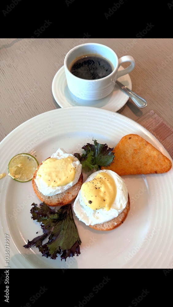Healthy breakfast of eggs Benedict paired with fresh greens and coffee. Eco-friendly and locally sourced ingredients. Nutritious and sustainable choice for delicious start to day. Healthy breakfast of eggs Benedict paired with fresh greens and coffee. Eco-friendly and locally sourced ingredients. Nutritious and sustainable choice for delicious start to day.