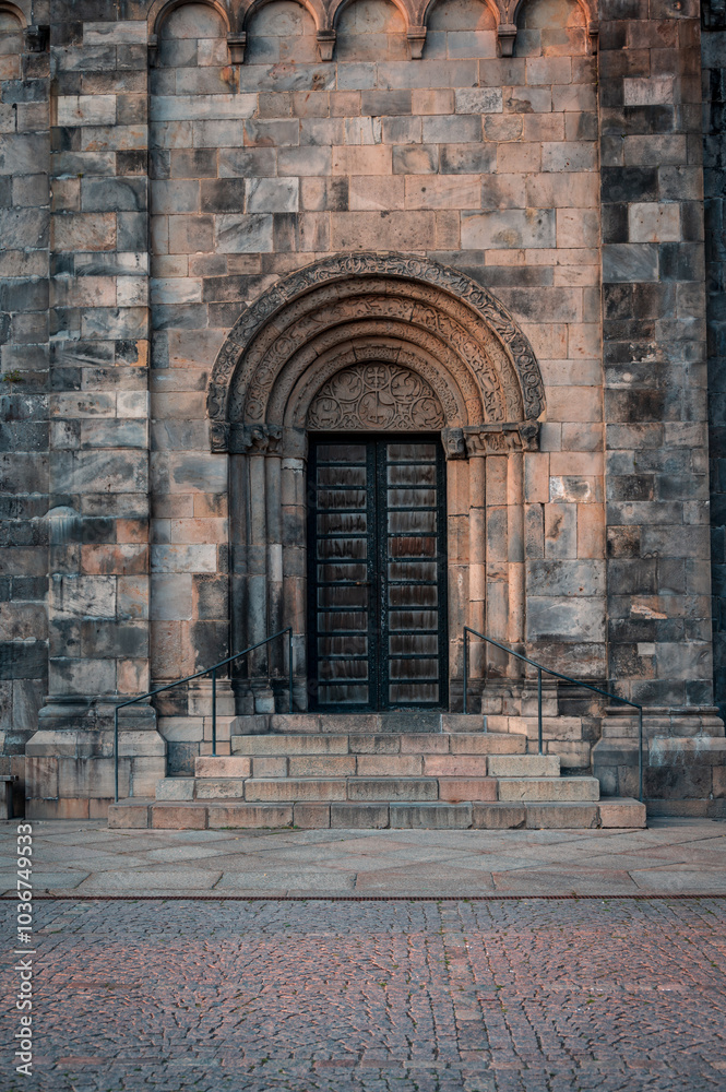 The side entrance to Lund cathedral in summer sunset The side entrance to Lund cathedral in summer sunset