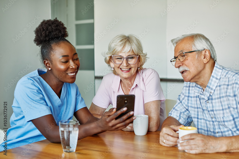 nurse senior couple home care mobile phone smartphone patient elderly retirement caregiver assistance nursing showing screen laughing using nurse senior couple home care mobile phone smartphone patient elderly retirement caregiver assistance nursing showing screen laughing using
