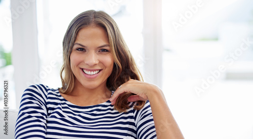 Portrait, house and girl on sofa, smile and happiness with weekend break, calm and peaceful. Face, apartment and cheerful person on couch, confidence or joy with wellness, comfort or woman in lounge