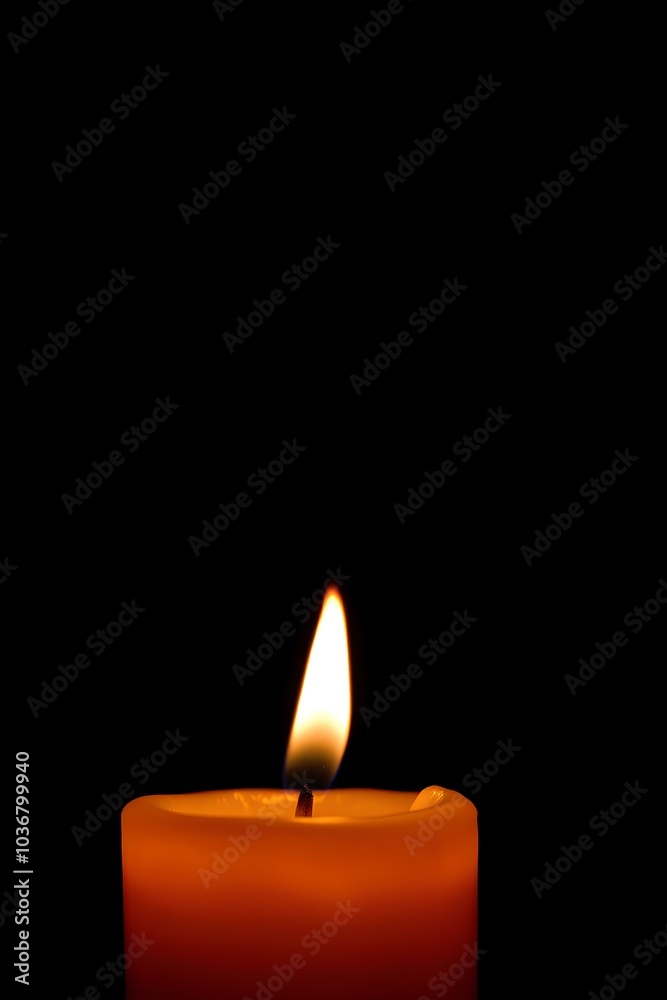 Burning candle on black background with space for text. For themes related to remembrance, mourning, loss or spirituality, hope and keeping the fire of life burning. Burning candle on black background with space for text. For themes related to remembrance, mourning, loss or spirituality, hope and keeping the fire of life burning.