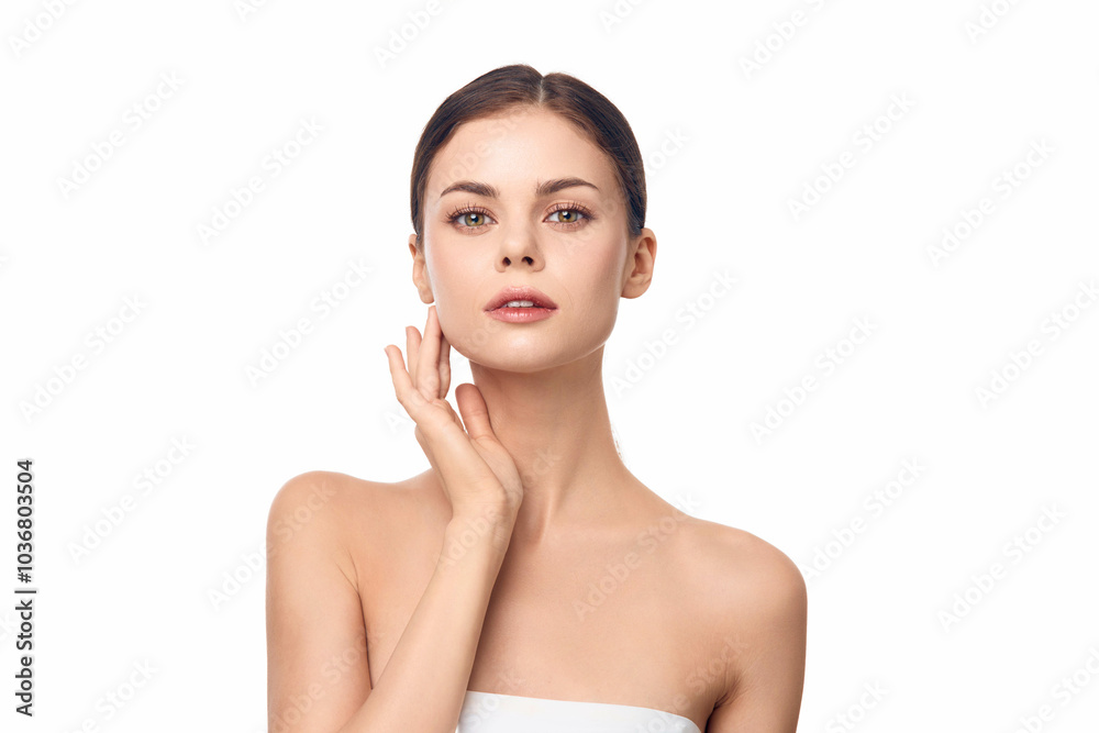 Woman in a towel smiling at camera against white background