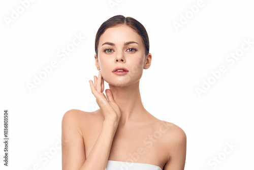 Woman in a towel smiling at camera against white background