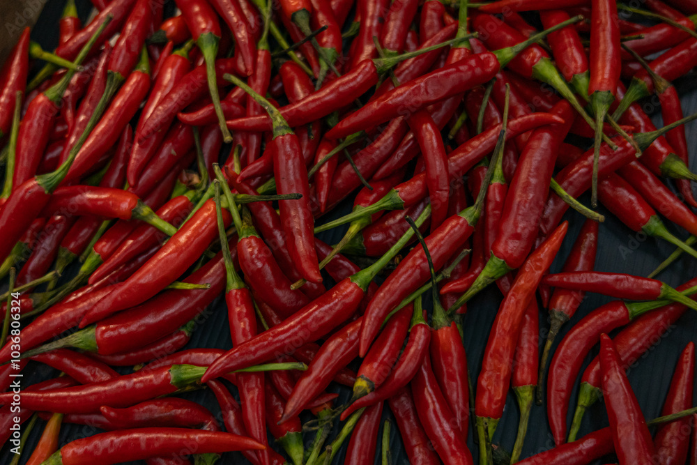 Top view of scattered red hot chili peppers, background. Top view of scattered red hot chili peppers, background.