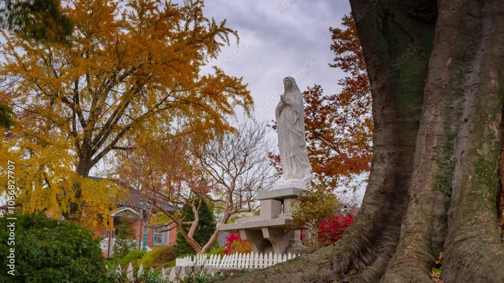 ASAN, SOUTH KOREA - OCTOBER 9, 2024: Statue surrounded by autumn foliage in a serene garden setting ASAN, SOUTH KOREA - OCTOBER 9, 2024: Statue surrounded by autumn foliage in a serene garden setting