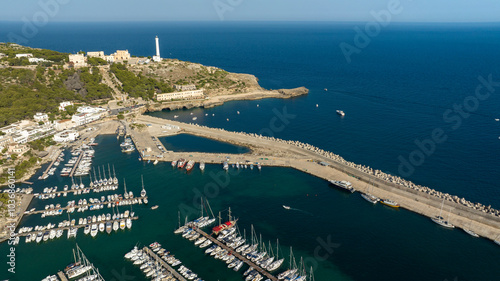 Aerial view of the Leuca lighthouse on the top of Punta Meliso. This is located in Santa Maria di Leuca in Salento, Puglia, Italy. In foreground is the touristic port of the city. photo