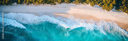 Aerial view of a white sandy beach and turquoise ocean waves, perfect for travel advertising. 