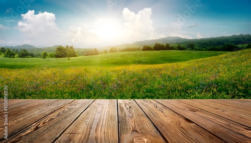 Bright serene landscape with brown wooden table or deck for product placement, sunlight meadow field blossoming vibrant wildflowers. outdoor nature tranquillity