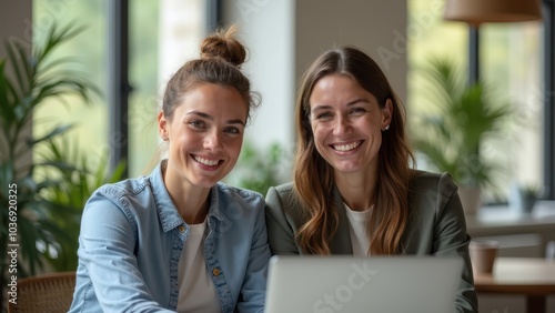 Two Happy Women Collaborating in a Modern Office Setting
