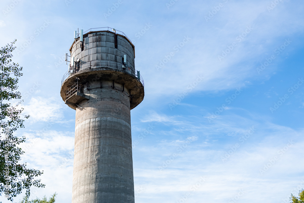 Old water tower with cell phone antennas. Old water tower with cell phone antennas.