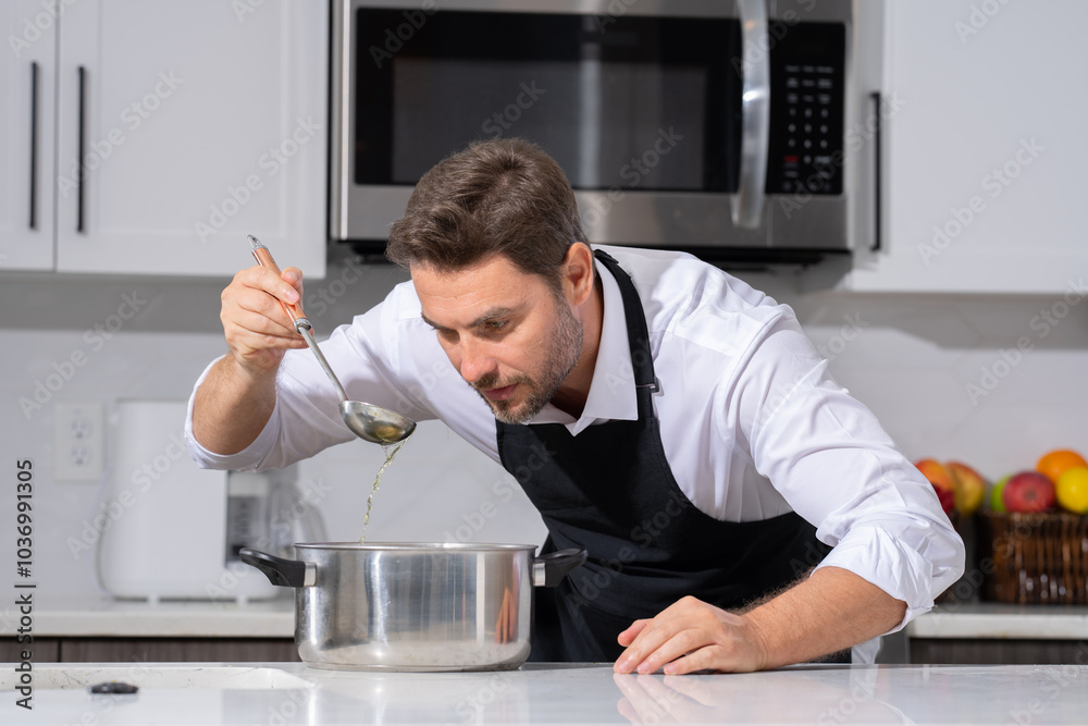 modern chef in professional uniform. close-up on the hand of male chef who is stirring soup in pot with spoon. cooking, culinary and people concept - male chef in toque with pot or saucepan. modern chef in professional uniform. close-up on the hand of male chef who is stirring soup in pot with spoon. cooking, culinary and people concept - male chef in toque with pot or saucepan.