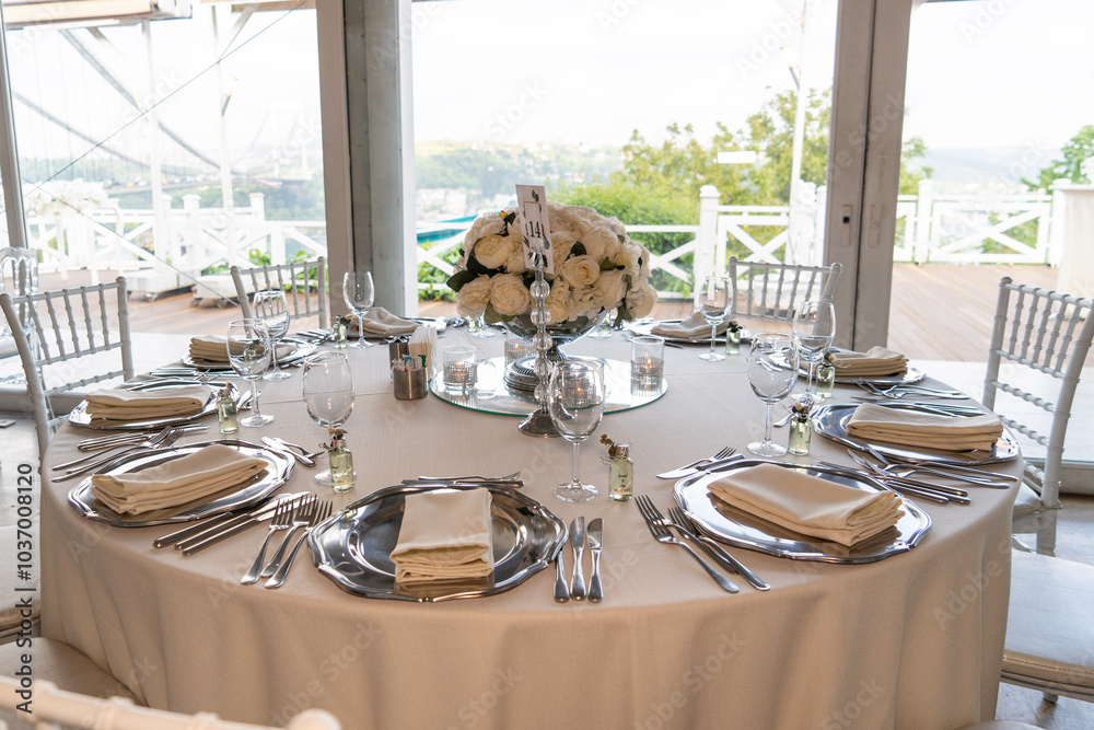 Elegant Wedding Reception Table Setting with Floral Centerpieces Overlooking Scenic Lake View